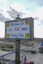 Sign with a wooden frame on a wooden post that says Welcome to Ventnor City that is located on the boardwalk near the beach