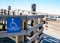Sign on a wooden handicapped accessible ramp for use by the disabled Royalty Free Stock Photo