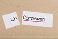 Sign with word unforeseen turned into foreseen Royalty Free Stock Photo