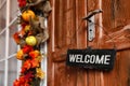 Sign with word WELCOME hanging. Traditional autumn holidays decoration