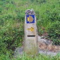 Landscape with yellow scallop shell signing the way to santiago de compostela on the Saint James pilgrimage route, Camino Royalty Free Stock Photo