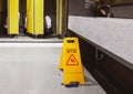 Sign yellow slippery warning floor wet, caution for toilet room cleaning progress. Safety sign with text caution