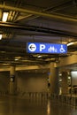 Signage and arrow show direction at indoor car park area.