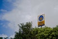 Signage of bharat petroleum standing from the middle of trees showing a fuel pump from one of the largest public sector