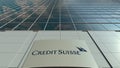 Signage board with Credit Suisse Group logo. Modern office building facade. Editorial 3D rendering