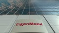 Signage board with ExxonMobil logo. Modern office building facade. Editorial 3D rendering