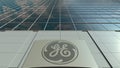 Signage board with General Electric GE logo. Modern office building facade. Editorial 3D rendering