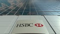 Signage board with HSBC logo. Modern office building facade. Editorial 3D rendering
