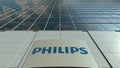 Signage board with Philips logo. Modern office building facade time lapse. Editorial 3D rendering