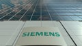Signage board with Siemens logo. Modern office building facade. Editorial 3D rendering