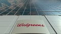 Signage board with Walgreens logo. Modern office building facade. Editorial 3D rendering Royalty Free Stock Photo