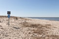 Signage found at Sunset Beach in Cape May New Jersey urging people to stay off the sand dunes which is the beautiful tall grass.