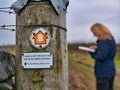 Signage marks the way of the Pennine Bridleway National Trail on a weathered wooden post.