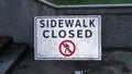 a signage with the message sidewalk closed