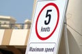 Signage showing maximum speed allowed in the port installations, safety background.