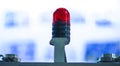 The signal lamp. Industrial red signal lamp on a blury industry background. The concept of security