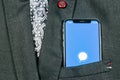 Signal messenger application icon on Apple iPhone X smartphone screen close-up in jacket pocket. Signal messenger app icon. Socia