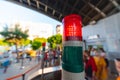 Signal with a red lamp. Green light. Attention the passage is closed. Selective focus. A large crowd of people in the background,
