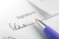 Signature of contract and agreement, accounting document with pen. Concept of banking, financial report and financial audit Royalty Free Stock Photo