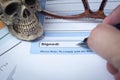 Signature field on document with pen and skull signed here; document is mock-up Royalty Free Stock Photo