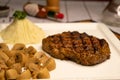 Signature Grilled Rib Eye Beef Steak with mushroom, dip, black pepper and garlic chilli sauce served in dish isolated on napkin Royalty Free Stock Photo