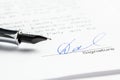 Signature in ink in the contract. Sheet of paper and pen close-up Royalty Free Stock Photo