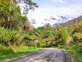 Signboard Awas meaning is danger in Malay language. Road path to somewhere idea concept. Wet on asphalt road.