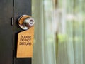 Signboard do not disturb hanging on open door in a hotel Royalty Free Stock Photo