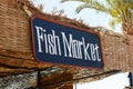 Signboard of fish market outdoor. Fish market sign on the beach with palm tree