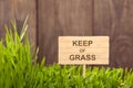 Signboard on keep of Grass background of wood planks,