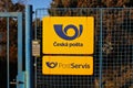 Signboard with logo of Czech Post company printed in blue text on yellow board