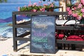 Signboard menu black color with an inscription - restaurant, orange, today, special, tuna steak. Chalkboard is standing near the