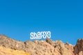 Signboard SHARM on the rocks on sky background. Travel background Royalty Free Stock Photo