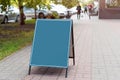 Signboard on the street. Empty menu board stand. Restaurant sidewalk chalkboard sign board. Freestanding A-frame blackboard near