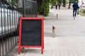 Signboard on the street. Empty menu board stand. Restaurant sidewalk chalkboard sign board. Freestanding A-frame Royalty Free Stock Photo