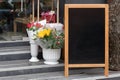 Signboard on the street. Empty menu board stand. Restaurant sidewalk chalkboard sign board. Freestanding A-frame blackboard near Royalty Free Stock Photo