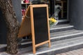 Signboard on the street. Empty menu board stand. Restaurant sidewalk chalkboard sign board. Freestanding A-frame blackboard near Royalty Free Stock Photo