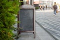 Signboard on the street. Empty menu board stand. Restaurant sidewalk chalkboard sign board. Freestanding A-frame blackboard near Royalty Free Stock Photo