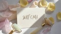 Self care card with rose petals crystals and facial rollers on white surface Royalty Free Stock Photo