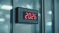 2026 Digital Clock Display. Red LED Digits On Metal Frame Indoors. Technology Time Indicator Concept For Countdown Year Mark Royalty Free Stock Photo