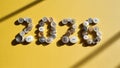 Button Digits 2026 On Yellow Background. Sewing And Craft Concept With Varied White Buttons Forming Numbers In Light And Shadow Royalty Free Stock Photo