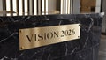 Gold Metal Plaque With Vision 2026 Text On Black Marble Reception Desk. Corporate Planning And Business Strategy Concept Royalty Free Stock Photo