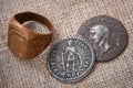 Signet ring and two coins of the ancient Roman Empire.