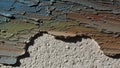 Significant cracking and flaking revealing a rough beige plaster Royalty Free Stock Photo