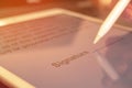 Signing the contract with digital signature on the tablet, close-up of document, stylus in hand, selective focus photo Royalty Free Stock Photo