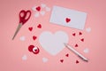 Signing Handmade Valentine`s cards. Felt, silver pen. white envelope, scissors.