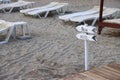 Signpost on the beach against the background of empty sunbeds, Alanya, Turkey, April 2021 Royalty Free Stock Photo