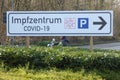 Signpost Covid-19 Impfzentrum means Covid-19 vaccination center. Parking lot signage. Royalty Free Stock Photo