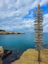 Signpost of direction of European capital cities on a wooden board in the coast against cloudy sky Royalty Free Stock Photo