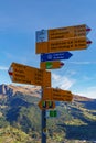 Signpost with directions to multiple destinations along the via alpina trail Royalty Free Stock Photo